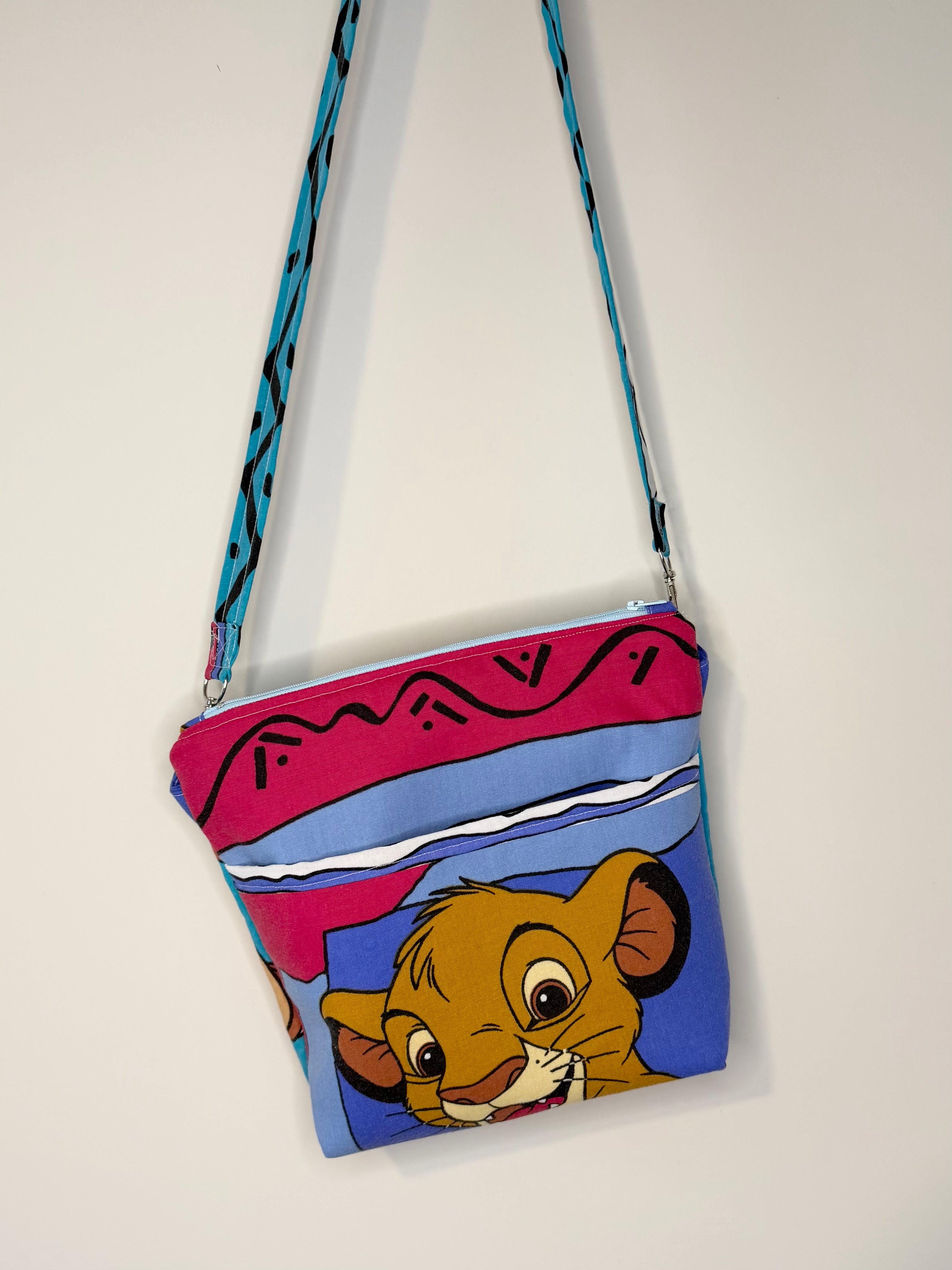 crossbody of little lion and warthog