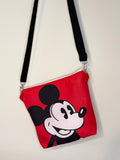 crossbody of mouse with red background