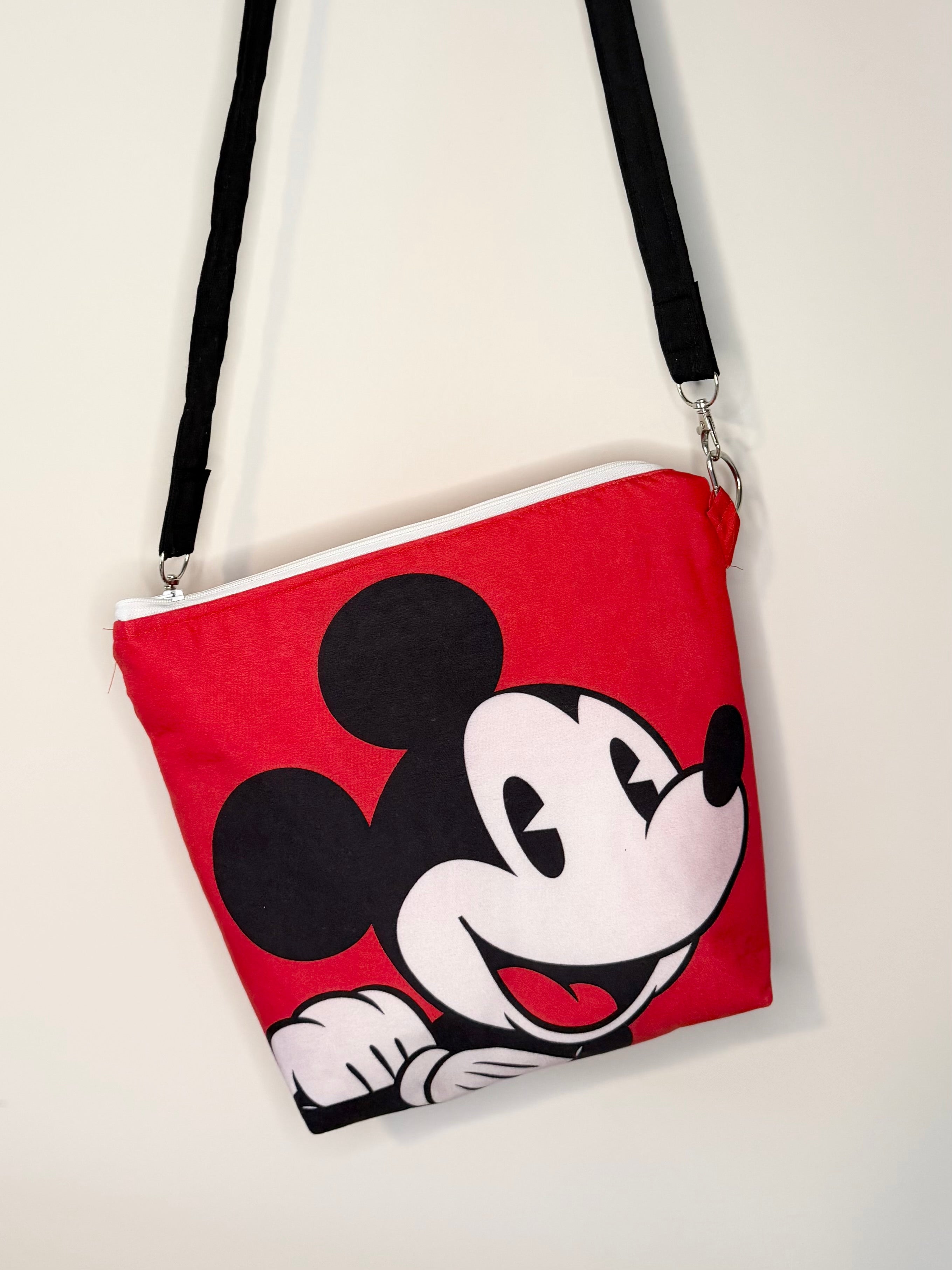 crossbody of mouse with red background
