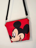 crossbody of mouse with red background